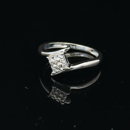 9ct white gold diamond cluster ring with a 10-point diamond, featuring a sparkling and elegant design.