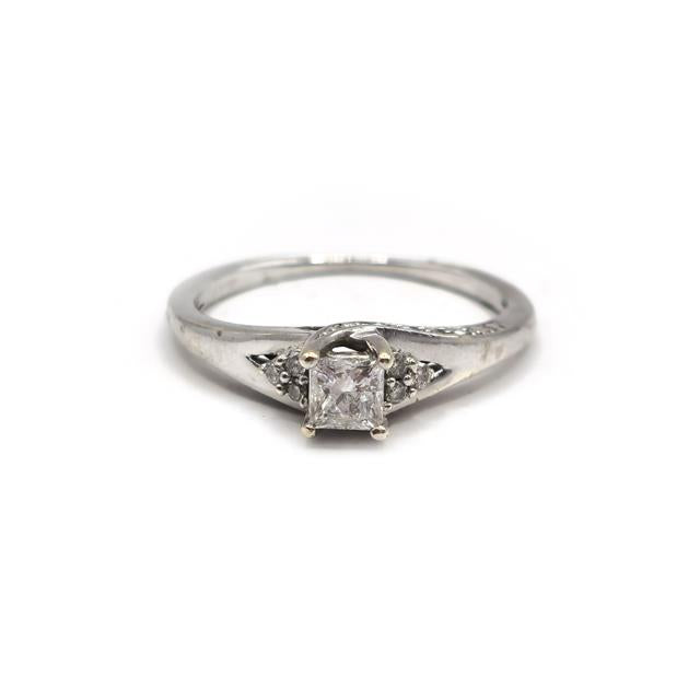 9ct white gold diamond ring with a sparkling central diamond, elegant jewelry piece showcasing fine craftsmanship.