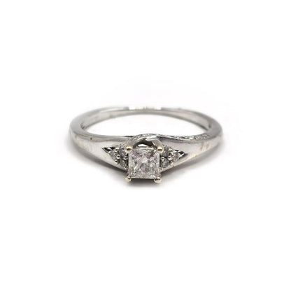 9ct white gold diamond ring with a sparkling central diamond, elegant jewelry piece showcasing fine craftsmanship.
