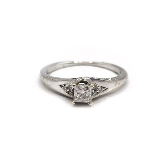 9ct white gold diamond ring with a sparkling central diamond, elegant jewelry piece showcasing fine craftsmanship.