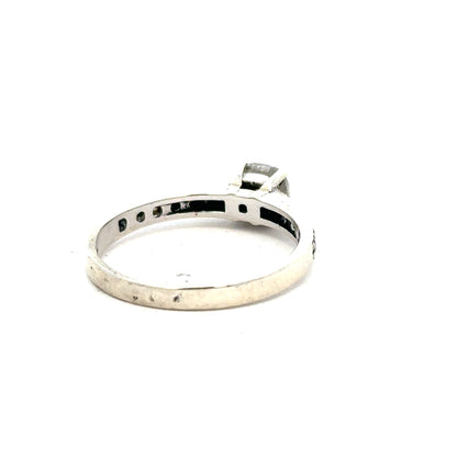 9ct white gold mossainte ring in size R, featuring a delicate gemstone set in a polished band.