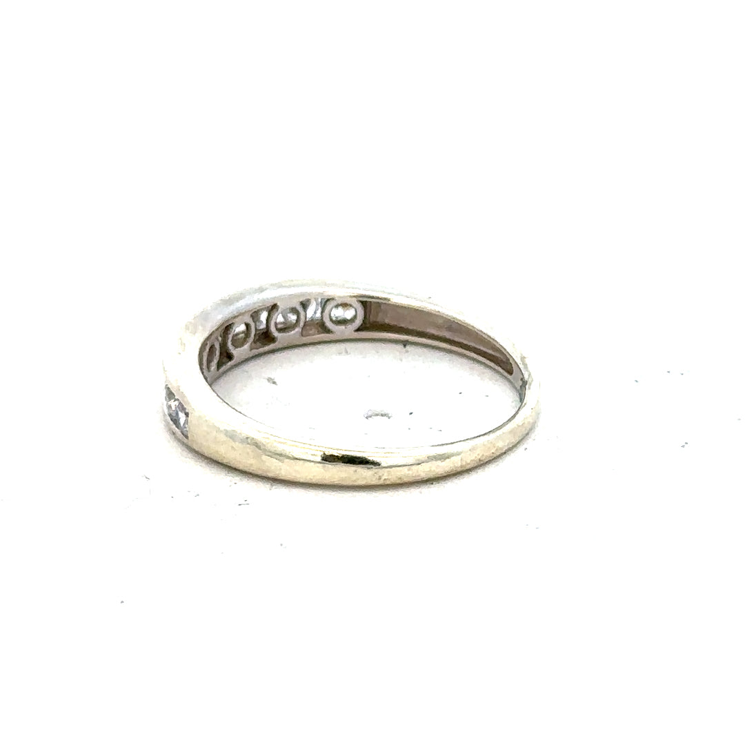 9ct white gold ring size L with a smooth band, photographed from above showing its polished finish and simple elegant design.