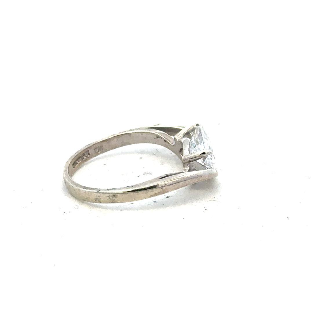 9ct white gold ring in size O with a smooth band, showcasing a shiny, polished finish. Unbranded jewelry.