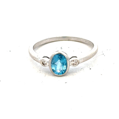 9ct white gold topaz and diamond ring, size Q, featuring a central blue topaz with diamond accents on a sleek band.