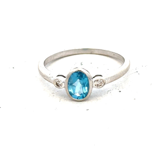 9ct white gold topaz and diamond ring, size Q, featuring a central blue topaz with diamond accents on a sleek band.