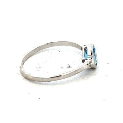 9ct white gold topaz and diamond ring, size Q, featuring a sparkling blue topaz center stone with diamond accents.