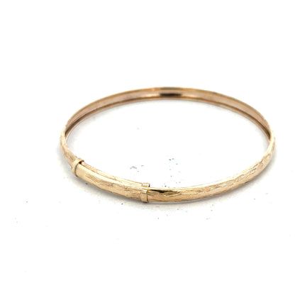 9ct yellow gold bangle weighing 1.7g, simple and elegant jewelry accessory, unbranded, displayed on a plain background