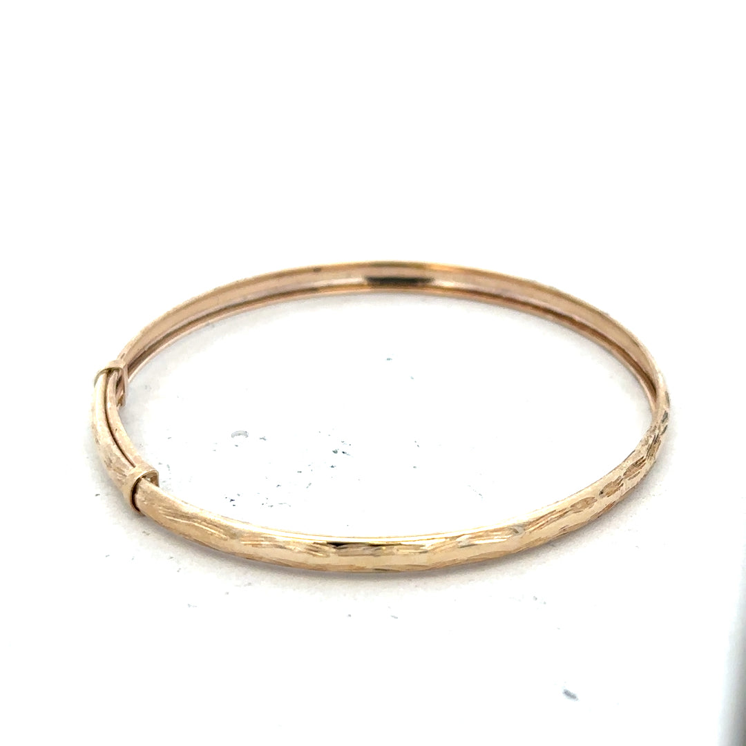 9ct yellow gold bangle with lightweight design, weighing 1.7g, featuring a sleek and polished finish.