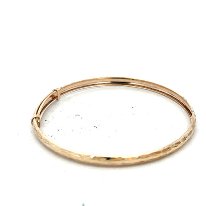 9ct yellow gold bangle with a sleek, polished finish, weighing 1.7g, designed for elegant wrist wear.