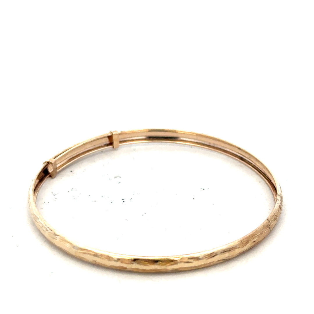9ct yellow gold bangle with a smooth, polished finish, weighing 1.7 grams, unbranded jewelry accessory.