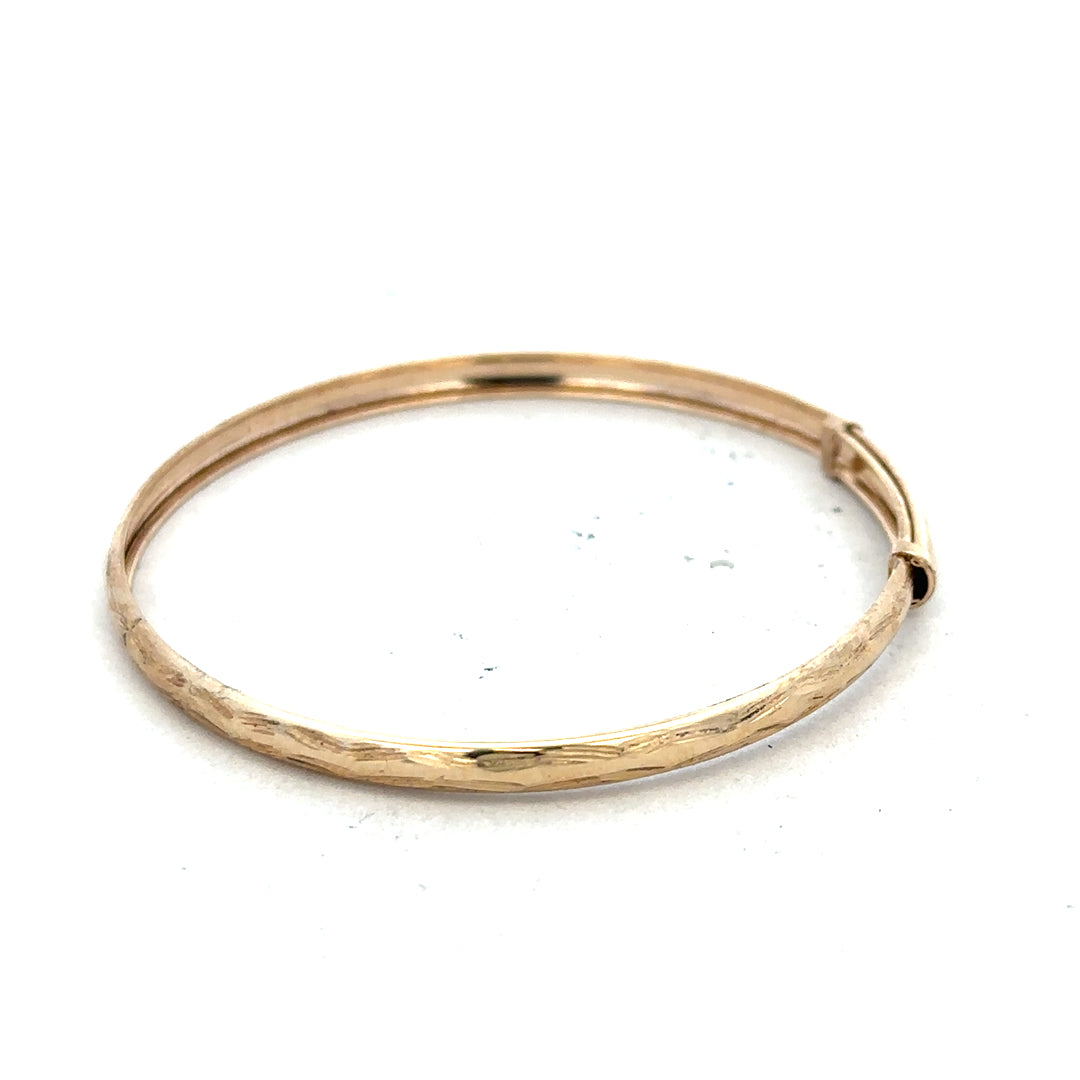 9ct yellow gold bangle weighing 1.7g, unbranded, with a smooth polished finish, displayed on a neutral background.
