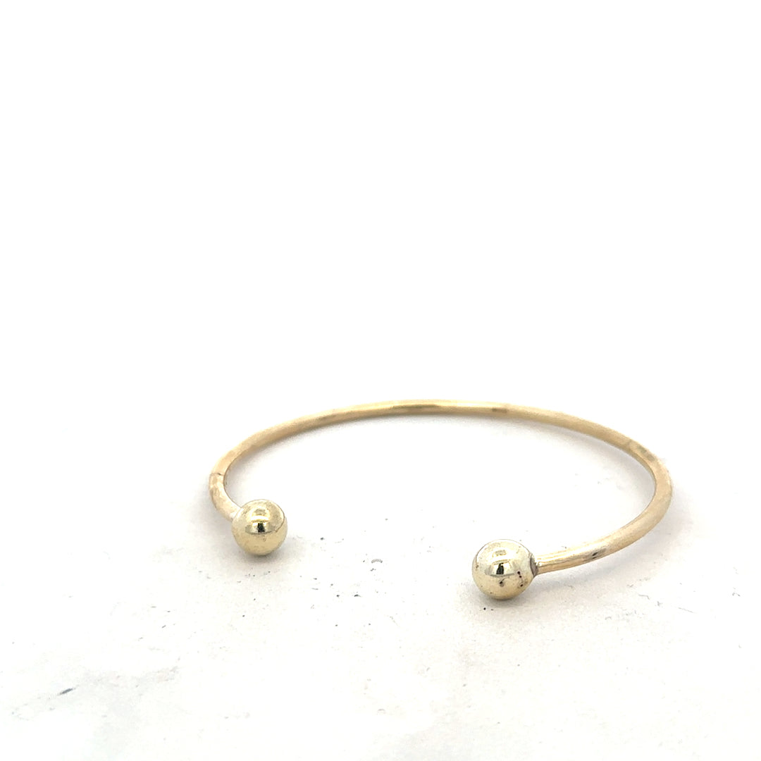 9ct yellow gold bangle weighing 12.7g, unbranded, with a smooth, polished finish and classic design, showcased on a white background.
