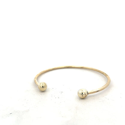 9ct yellow gold bangle weighing 12.7g, unbranded, with a smooth, polished finish and classic design, showcased on a white background.