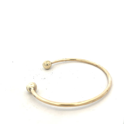 9ct yellow gold bangle weighing 12.7g, unbranded, with a smooth polished finish and classic circular design.