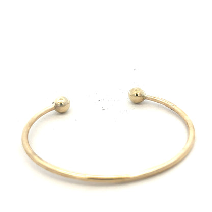 9ct yellow gold bangle weighing 12.7g, unbranded jewelry accessory, circular gold bangle with smooth finish.