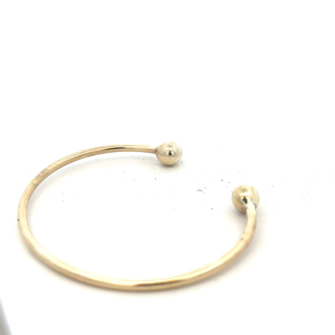 9ct yellow gold bangle with 12.7g weight, featuring a smooth, polished finish and a classic design, unbranded jewelry accessory.