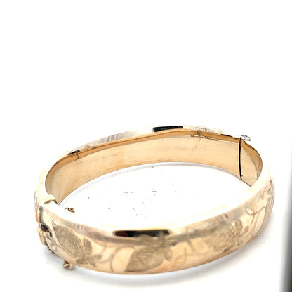 9ct yellow gold bangle weighing 20.3g, unbranded, with a smooth polished finish and rounded design.