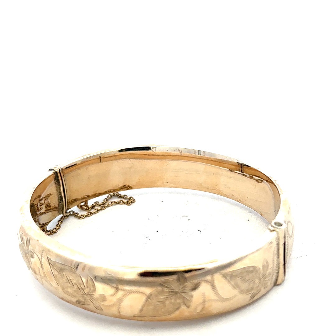 9ct yellow gold bangle weighing 20.3g, unbranded, with a smooth polished finish, displayed on a neutral background.