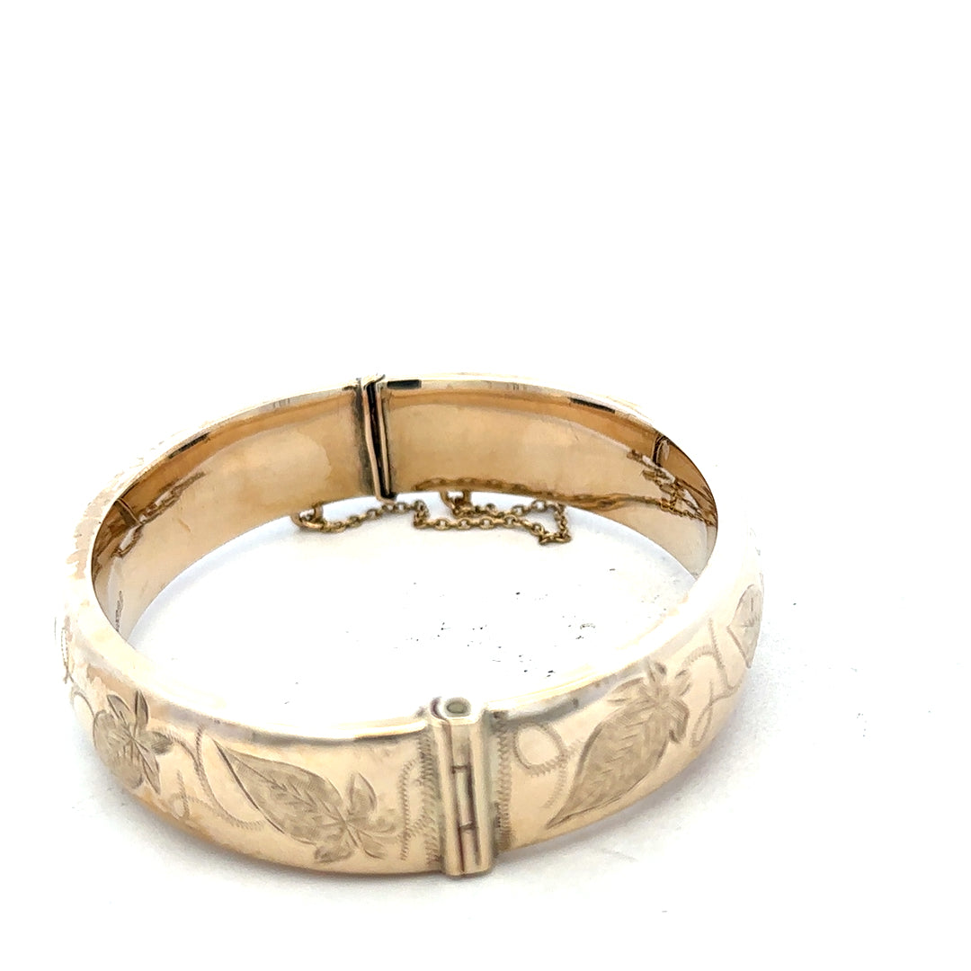 9ct yellow gold bangle weighing 20.3g, unbranded, with a smooth, polished finish, shown on a plain background.