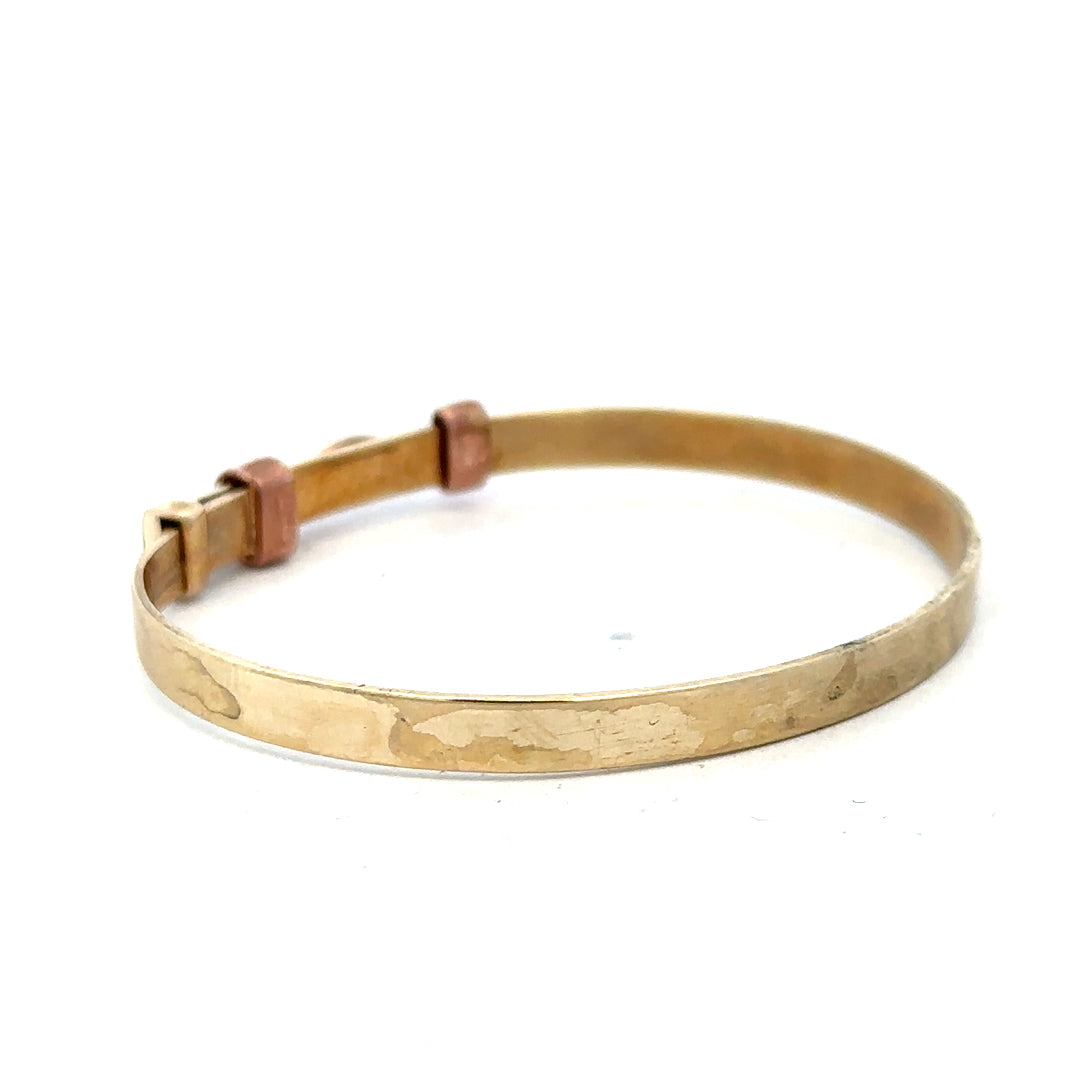 9ct yellow gold bangle with a sleek design, weighing 6.3g, showcasing a classic and elegant jewelry piece.