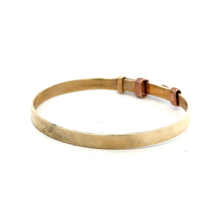 9ct yellow gold bangle weighing 6.3g, unbranded, with a smooth polished finish and simple circular design.