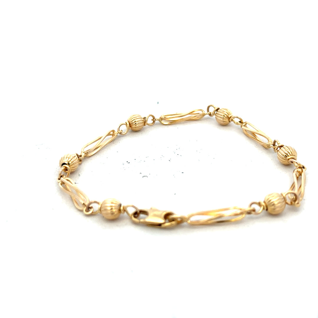 9ct yellow gold bracelet weighing 5.3g, featuring a classic chain design, unbranded jewelry shown on a neutral background.