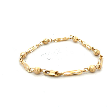 9ct yellow gold bracelet weighing 5.3g, featuring a classic chain design, unbranded jewelry shown on a neutral background.