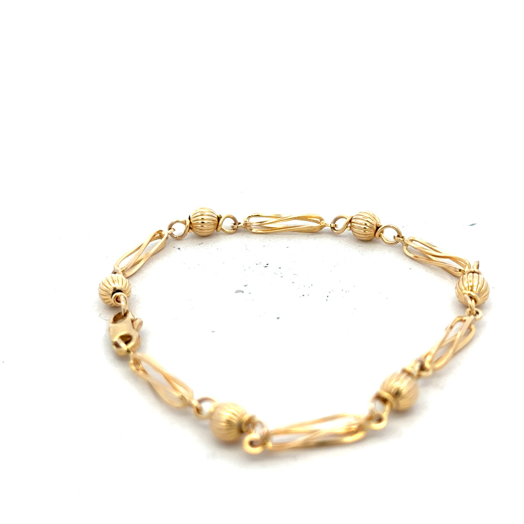 9ct yellow gold bracelet weighing 5.3g, featuring a sleek and elegant design, shown in a close-up view.