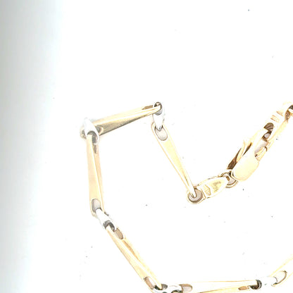 9ct yellow gold bracelet weighing 8.9g, featuring a delicate chain design, displayed on a neutral background.