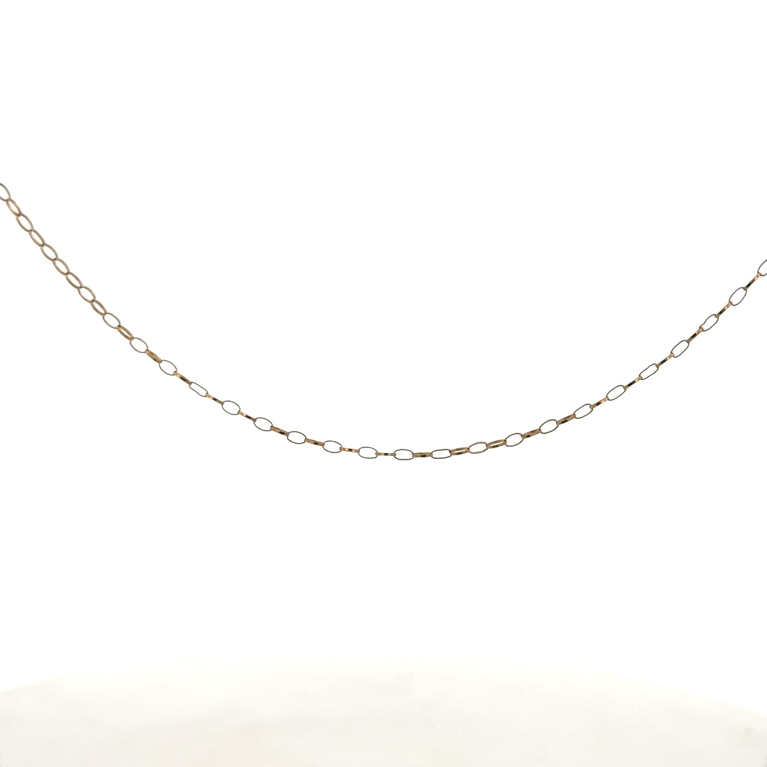 9ct yellow gold chain weighing 0.7g, unbranded, shown in a close-up image highlighting its fine link design.
