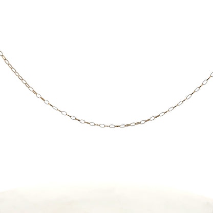 9ct yellow gold chain weighing 0.7g, unbranded, shown in a close-up image highlighting its fine link design.