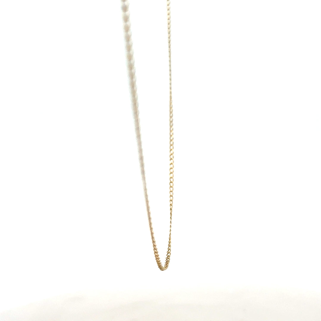 9ct yellow gold chain weighing 1.3g, showcasing a delicate jewelry piece with a smooth link design.