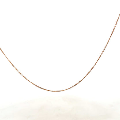 9ct yellow gold chain weighing 1.4g, unbranded jewelry with a delicate design, shown in close-up on a plain background.