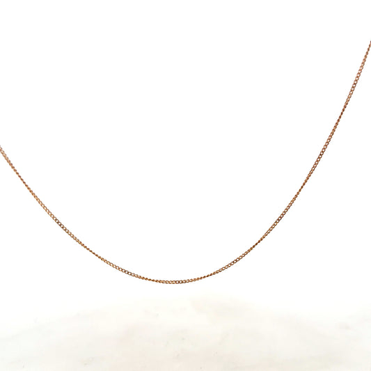 9ct yellow gold chain weighing 1.4g, unbranded jewelry with a delicate design, shown in close-up on a plain background.