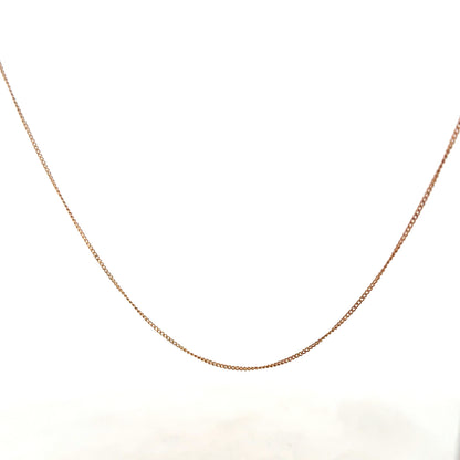 9ct yellow gold chain weighing 1.4g, unbranded jewelry accessory with a delicate design, shown in close-up image.