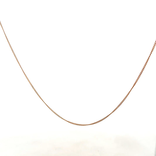 9ct yellow gold chain weighing 1.4g, unbranded jewelry accessory with a delicate design, shown in close-up image.