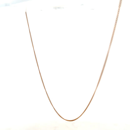 9ct yellow gold chain weighing 1.4g, unbranded, with a delicate link design, shown against a neutral background.