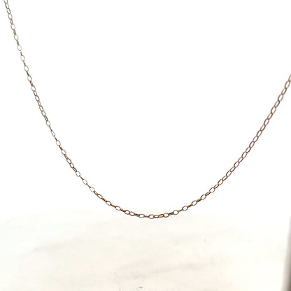 9ct yellow gold chain with 1g weight, showcasing a delicate, shiny gold jewelry piece on a neutral background.