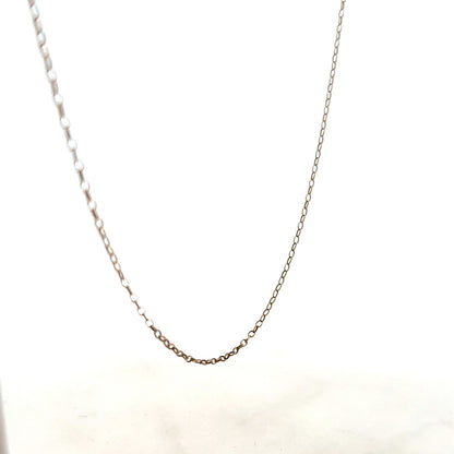 9ct yellow gold chain weighing 1g, unbranded jewelry accessory with a delicate link design, shown in close-up.