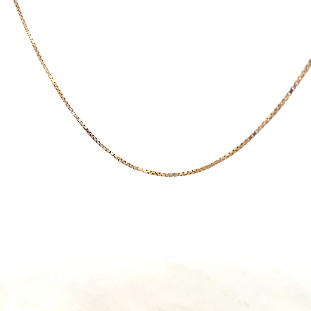 9ct yellow gold chain weighing 6.1g, featuring a classic link design, photographed against a plain background.