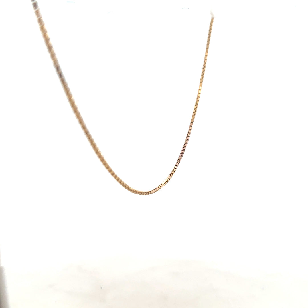9ct yellow gold chain weighing 6.1g, unbranded, with a classic link design, shown in a detailed close-up image.