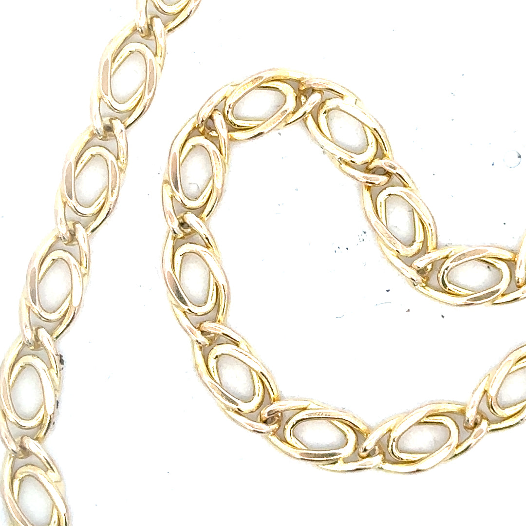 9ct yellow gold chain, 7.8g, unbranded, with a classic link design, shown in a close-up image highlighting its shine and craftsmanship.