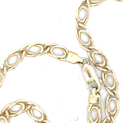 9ct yellow gold chain weighing 7.8g, featuring a classic link design, unbranded jewelry piece, shown on a plain background.