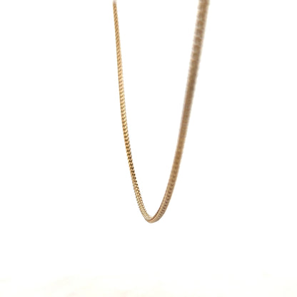 9ct yellow gold chain weighing 9.2g, unbranded, with a detailed close-up of the chain's links and shine.