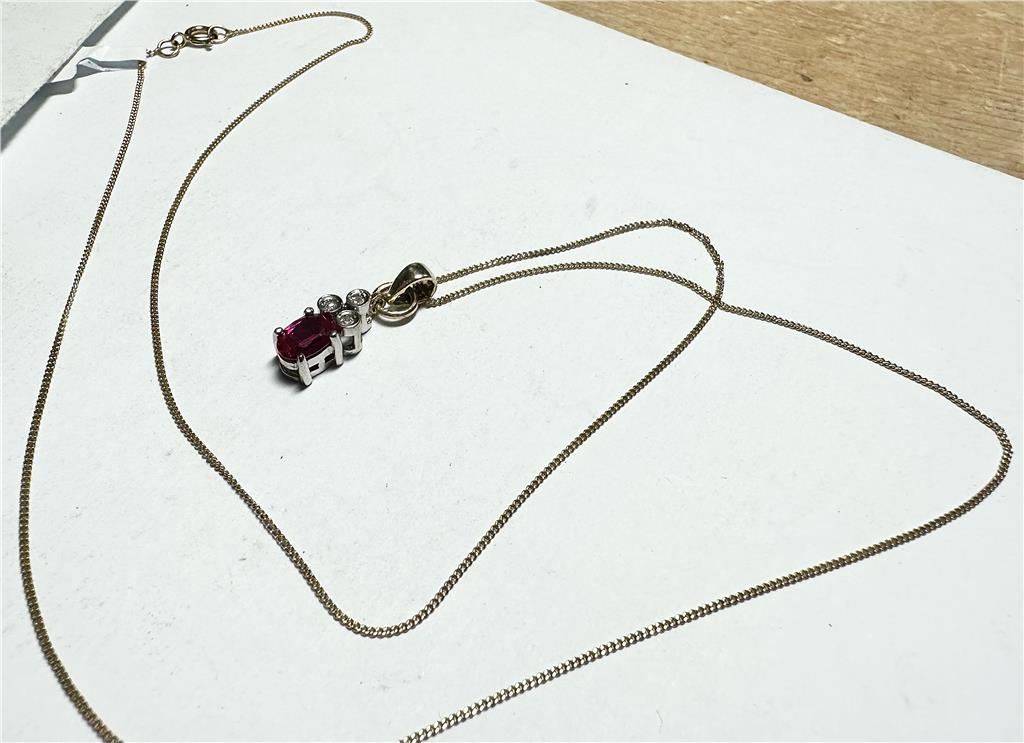 9ct yellow gold chain with diamond pendant, showing the elegant design and sparkling gemstone in close-up shot.