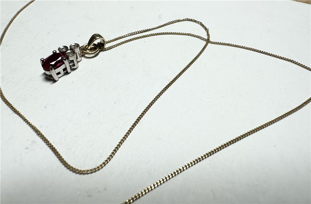 9ct yellow gold chain with diamond pendant, showcasing a delicate gold chain and sparkling diamond detail.