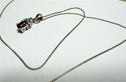 9ct yellow gold chain with diamond pendant, showcasing a delicate gold chain and sparkling diamond detail.