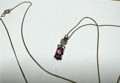 9ct yellow gold chain with diamond pendant, showcasing a delicate design and sparkling gemstone on a white background.