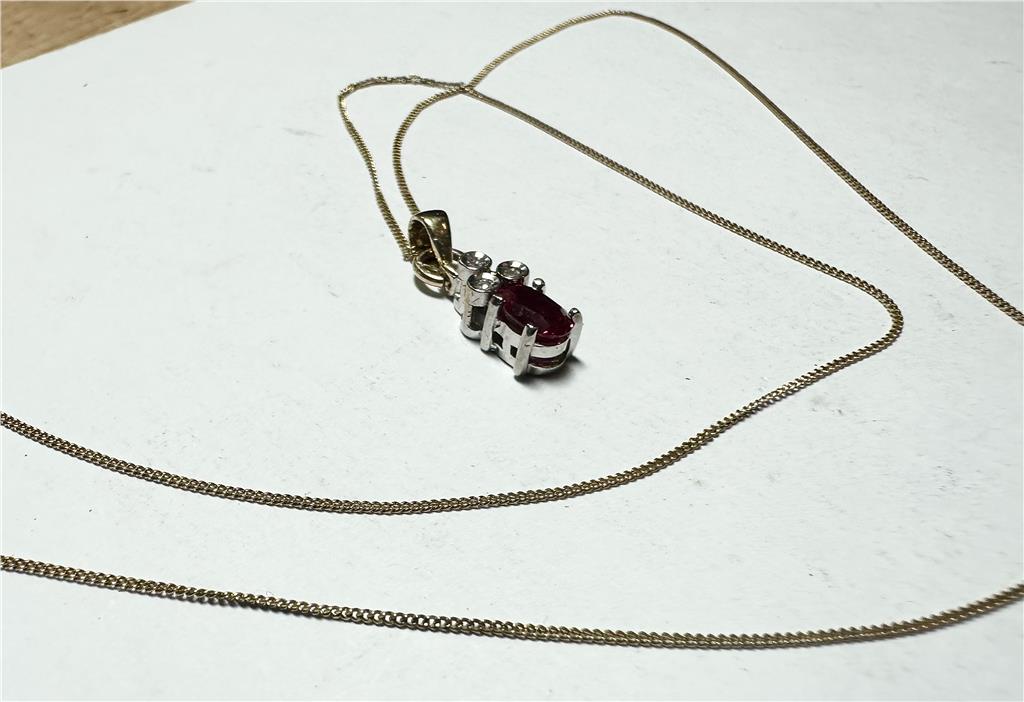 9ct yellow gold chain with diamond pendant, showcasing a delicate gold chain and sparkling diamond detail.