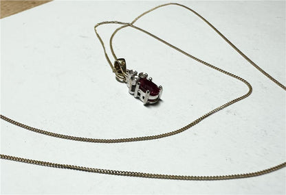 9ct yellow gold chain with diamond pendant, showcasing a delicate gold chain and sparkling diamond detail.